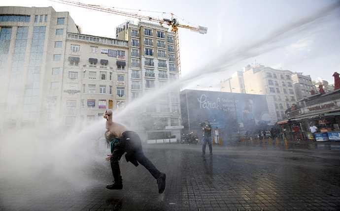 Turkish riot police use water cannon to disperse demonstrators during a protest against the destruction of trees in a park brought about by a pedestrian project, in Taksim Square in central Istanbul