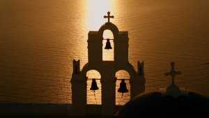 A beautiful sunset behind a Greek Orthodox Church on the Greek Island Santorini